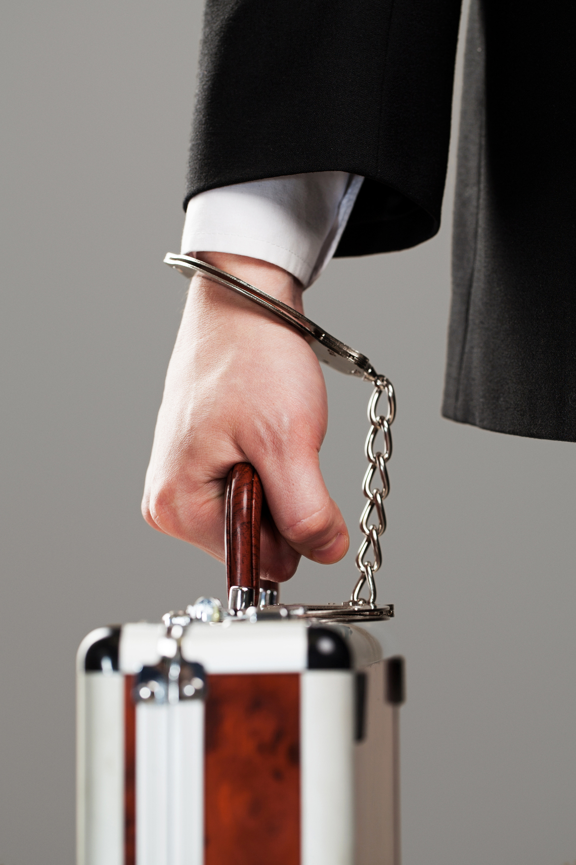 Case attached to hand with handcuffs asesoramiento contable